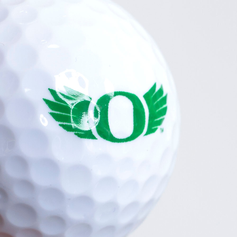 https://www.uoduckstore.com/TDS%20Product%20Images/White%20Spirit%20Titleist%203%20Ball%20Sleeve%20w%20Green%20O%20with%20Wing%20Golf%20Ball_2.jpg